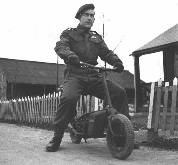 Một sĩ quan đang tạo dáng trên chiếc xe máy mini Welbike
